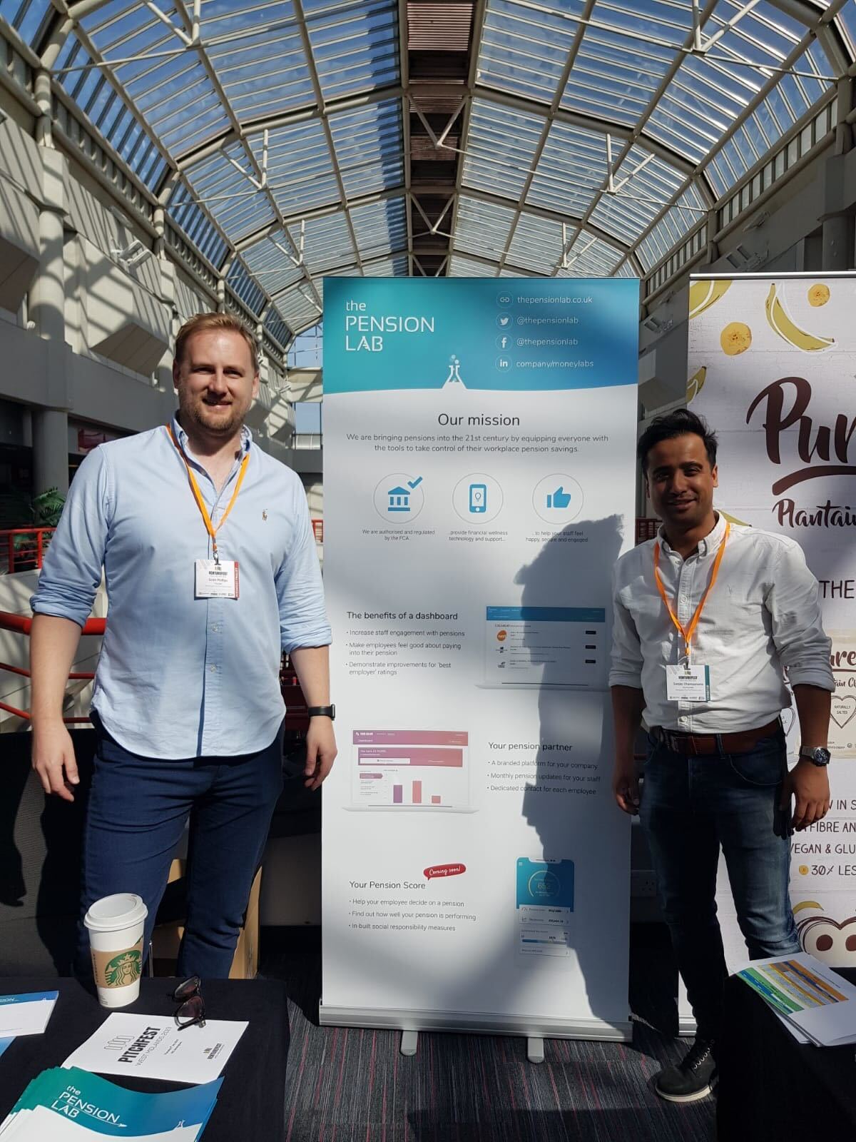 Two people standing at the Pension Lab stand